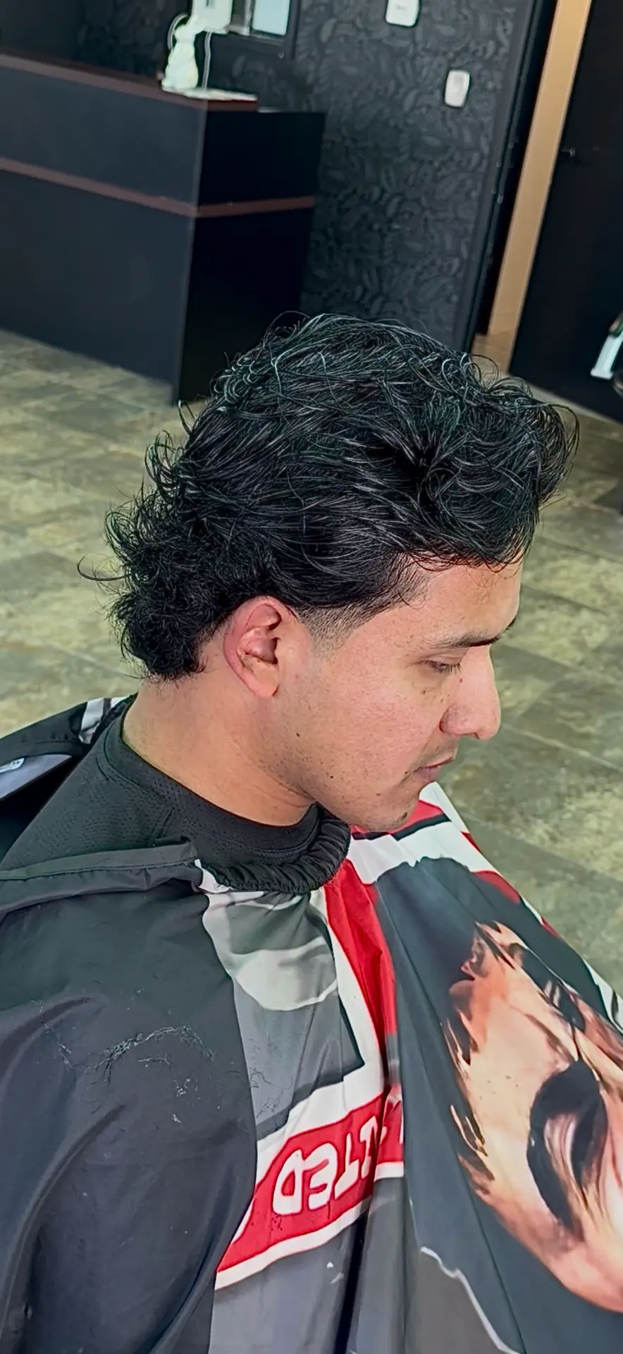 Client with a curly top and tapered fade